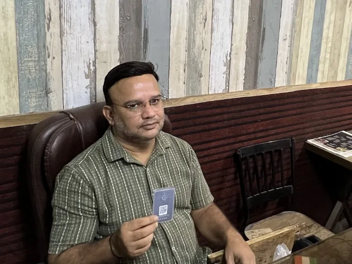 Mr. Mohsin Abbas of Al Mustafa Restaurant holding his TapStar All-in-One business card at his restaurant