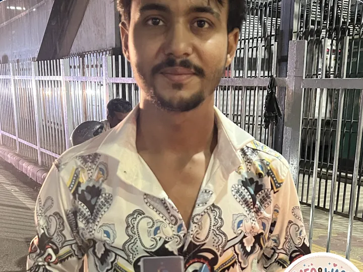 Mr. Adil of Meow & Waow pet shop holding his TapStar Google review card